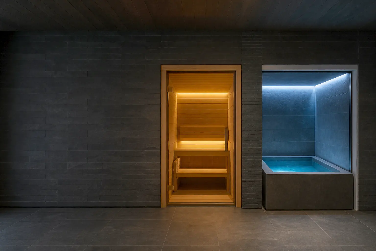 Stone walkway forking at dusk — one branch lit warm toward a sauna cabin, the other cool blue toward a cold plunge pool